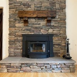 Ambassador Fireplaces - New efficient Regency wood insertn new srone work and mantel.