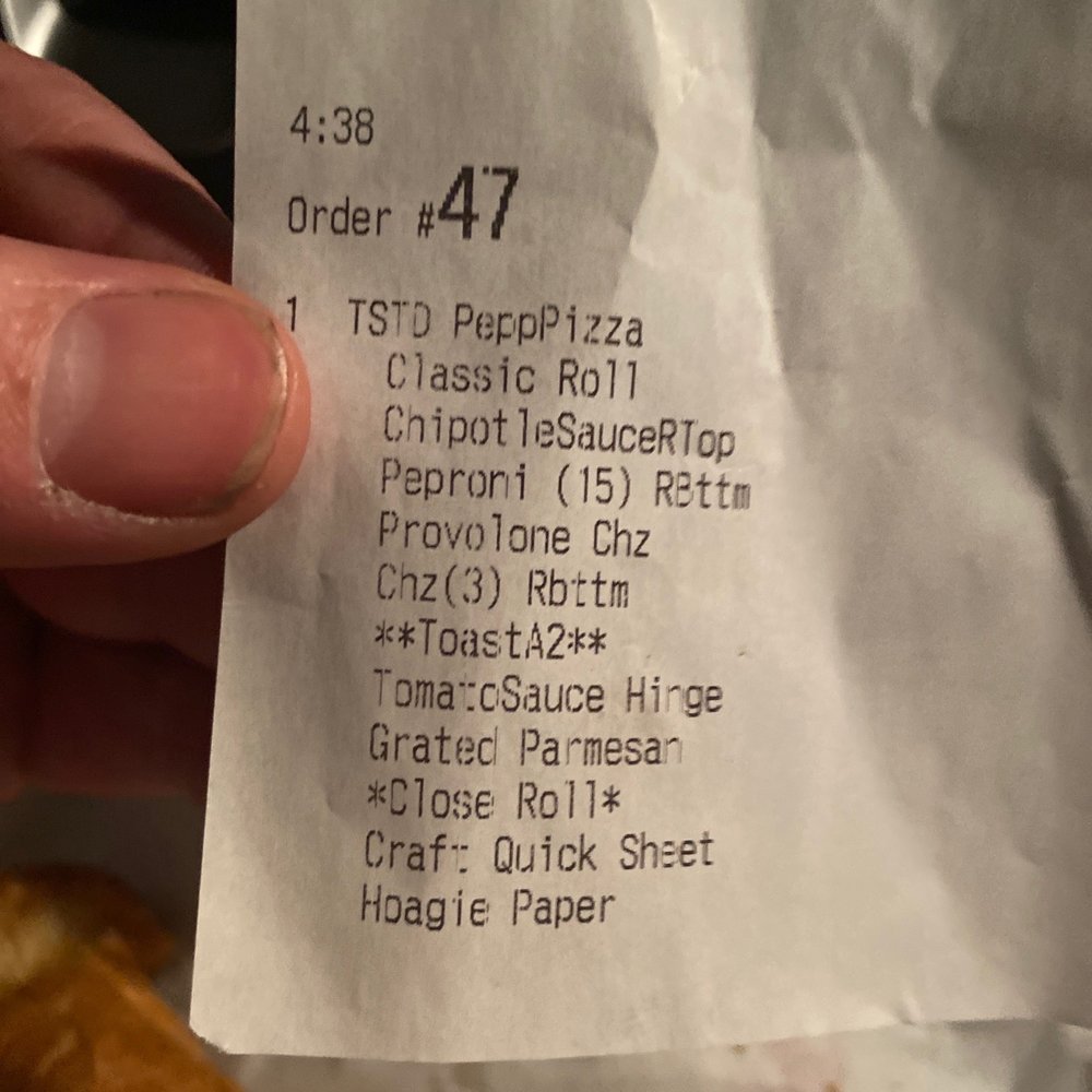 Wawa - a person holding a piece of food - Convenience Stores Near Me - Richmond, Virginia