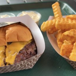 a cheeseburger and fries on a tray a cheeseburger and fries on a tray