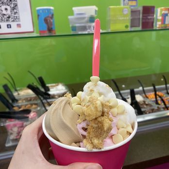 The Yogurt Experience - a hand holding a cup of ice cream - Ice Cream & Frozen Yogurt Near Me - Round Rock, Texas