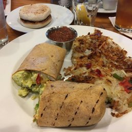 Breakfast burrito with onions peppers, crispy hash browns on the side, really good Breakfast burrito with onions peppers, crispy hash browns on the side, really good