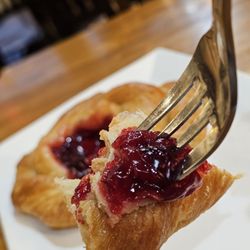 One Love Coffee House - A fork holding a piece of my nice and fresh Cherry Danish.