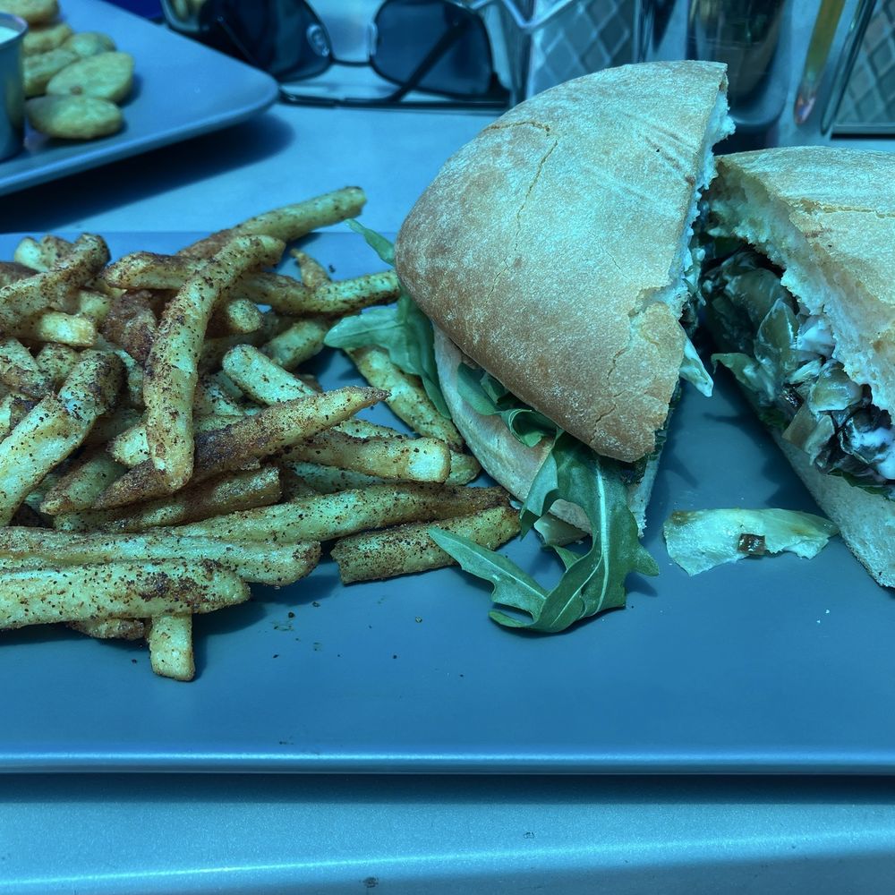 Steak Sando with fries, the blue hue is from the overhead tarp. Steak Sando with fries, the blue hue is from the overhead tarp.