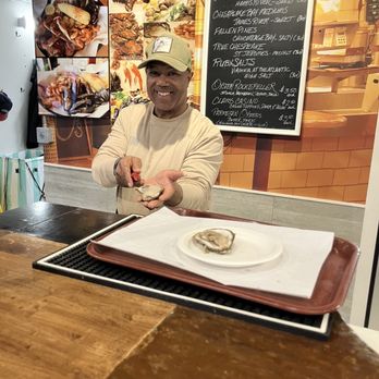 Faidley's Seafood - Opening the oyster right after you order - Seafood Markets Near Me - Baltimore, Maryland Faidley's Seafood - Opening the oyster right after you order - Seafood Markets Near Me - Baltimore, Maryland