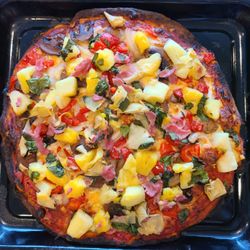 Blue Hummingbird GF Foods - Veggie pizza with added pineapple, ham and artichoke hearts.