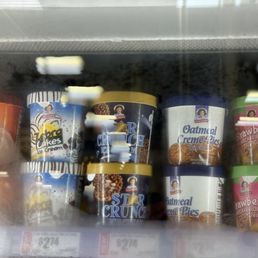 Childhood favorites in the form of ice cream - Multiple ice cream containers with various flavors are arranged on a shelf inside a freezer at H-E-B in Bee Cave, TX.