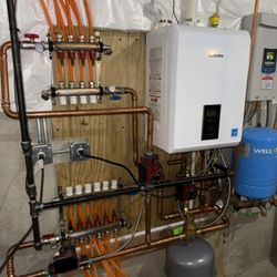 Ferraro HVAC - Brand new Navien modulating boiler system with in floor radiant heating in the basement and garage for nice toasty warm that you can feel.