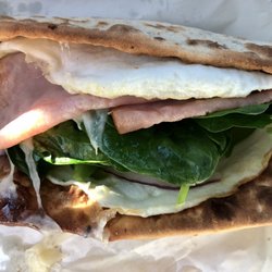 Breakfast Flatbread Sandwich with ham, egg white, Swiss Cheese, bell peppers, onion, spinach. Requested flat bread extra toasted. Yum!