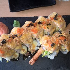 Photo of Yami Sushi Bistro - Prague, Czech Republic. Custom sushi roll - two proteins (spicy tuna and fried shrimp), mango and avocado inside, tons of deliciousness on the outside. Yum!