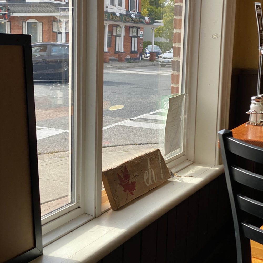 Copper Kettle Cafe - a view of a street through a window - Cafes Near Me - Waterdown, Ontario