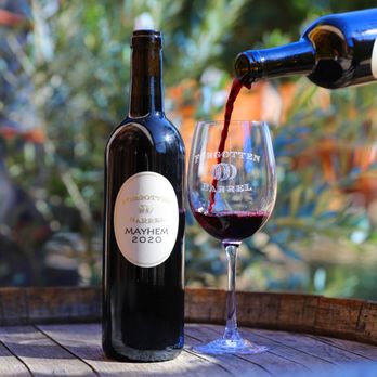 Forgotten Barrel Winery - a bottle of wine being poured into a glass - Wine Tasting Room Near Me - Escondido, California Forgotten Barrel Winery - a bottle of wine being poured into a glass - Wine Tasting Room Near Me - Escondido, California