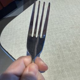 Food stuck on fork - dirty silverware Food stuck on fork - dirty silverware