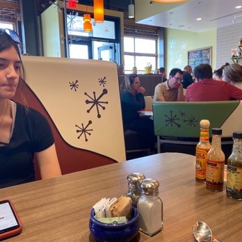 Snooze, an A.M. Eatery - Char checking out the hot sauce selection...... - Breakfast & Brunch Near Me - Orange, California