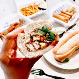 Tofu Banh Mi, tofu appetizer in back, fries & veggie egg rolls Tofu Banh Mi, tofu appetizer in back, fries & veggie egg rolls