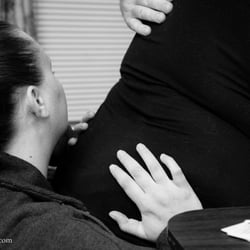 Utah Doula Services - Providing counter-pressure during a birthing wave while Dad supports and loves on her