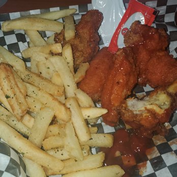 VIBES Bar&Grill - a plate of chicken wings and french fries - Bars Near Me - Humble, Texas