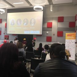 Rise Demonstration Center - A stage, a panel, and a screen at The RISE