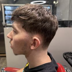 Legends Grooming Lounge - Taper fade on sides and back of head with slight fluffy and messy look on top!