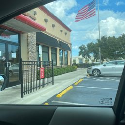 ows an american flag flying in front of a restaurant ows an american flag flying in front of a restaurant