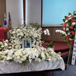 Rainforest Florals - Memorial service spray and flowers around the picture.