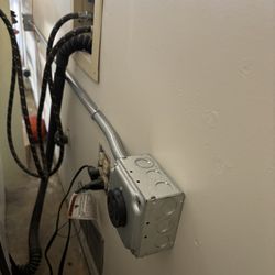 New NEMA14-30 outlet, surface mounted and conduit connecting new breaker in sub-panel.