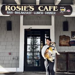 Front of the cafe with my wife and dog named Rosie