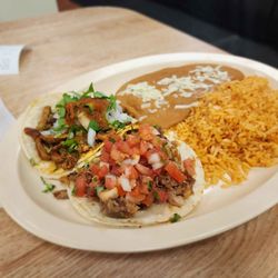 Taqueria Los Pericos - Two tacos (al pastor, carnitas) with rice and beans.