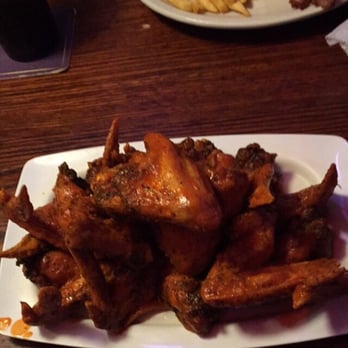 The Peanut - Dozen wings and in the back is the BLT with fries. AMAZING - American Near Me - Overland Park, Kansas