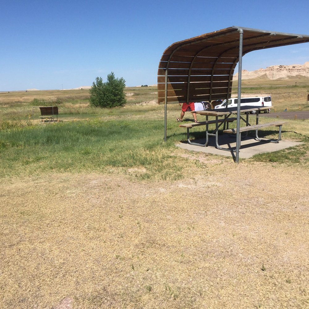 Cedar Pass Campground - Our campsite included this picnic table with built in shade that worked for part of the time. We attached our tarp to this for more shade. - Campgrounds Near Me - Interior, South Dakota