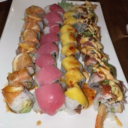 Left - right: Sunset Roll $15.95 Double Tuna Roll $15.95 Mango Roll $15.95 Firecracker Roll $15.95 Left - right: Sunset Roll $15.95 Double Tuna Roll $15.95 Mango Roll $15.95 Firecracker Roll $15.95
