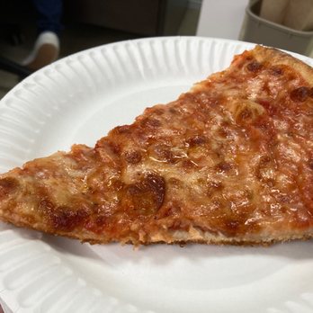 Bonillas Pizza - a slice of pizza on a paper plate - Pizza Near Me - Wyandanch, New York Bonillas Pizza - a slice of pizza on a paper plate - Pizza Near Me - Wyandanch, New York