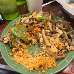 El Nopalito Grill - Chicken, steak, and shrimp over rice with peppers and onions