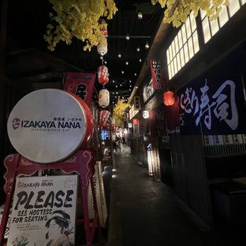 Izakaya Nana - Japan street scene - from reception desk start of corridor with private seating and raised rooms areas - Izakaya Near Me - Flushing, New York