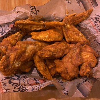 Roosters - a basket of chicken wings and a glass of beer - Chicken Wings Near Me - Cincinnati, Ohio