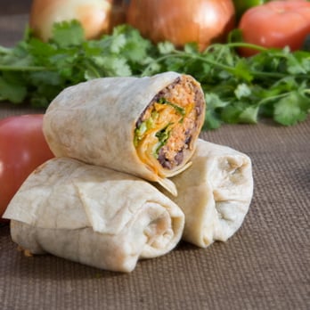Burritos - a burrito cut in half with vegetables in the background - Mexican Near Me - Yardley, Pennsylvania