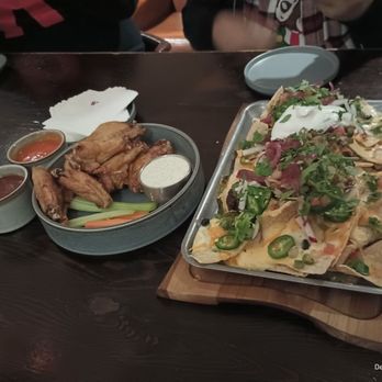 The Bar- Born and Raised - Barbacoa Nachos and bourbon chipotle and buffalo wings . - Cocktail Bars Near Me - San Antonio, Texas The Bar- Born and Raised - Barbacoa Nachos and bourbon chipotle and buffalo wings . - Cocktail Bars Near Me - San Antonio, Texas
