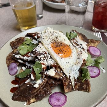 Manuela - Black Beans Chilaquiles, Crema, Fried Egg, Radish, Cilantro - New American Near Me - Los Angeles, California Manuela - Black Beans Chilaquiles, Crema, Fried Egg, Radish, Cilantro - New American Near Me - Los Angeles, California