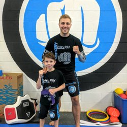 Victory MMA Academy - Arlington Heights - My son with Sensei Alex after being awarded his purple belt.
