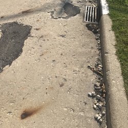 Department of Motor Vehicles - DMV Elgin, Il parking lot garbage, road damages