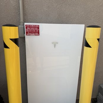 SunLux - Tesla Powerwall with the two required safety poles that I will be removing! - Solar Installation Near Me - Corona, California