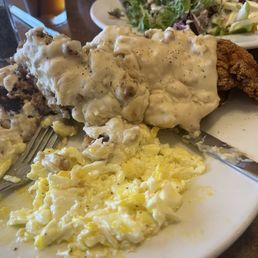 Fried chicken in biscuit with gravy and eggs. Sorry, dug in before the pic. Fried chicken in biscuit with gravy and eggs. Sorry, dug in before the pic.