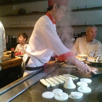 Benihana - a man cooking food in a restaurant - Teppanyaki Near Me - The Bronx, New York