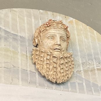 Bakkhus Taverna - a statue of a bearded man - Greek Near Me - Kemah, Texas