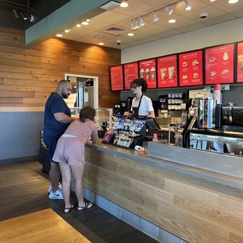 Starbucks - a woman ordering coffee at a counter - Coffee & Tea Near Me - Aventura, Florida Starbucks - a woman ordering coffee at a counter - Coffee & Tea Near Me - Aventura, Florida