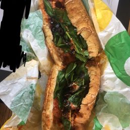 two sub sandwiches on a piece of paper two sub sandwiches on a piece of paper