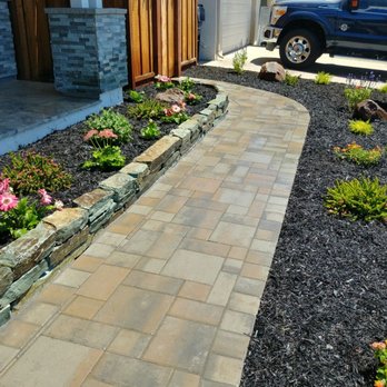 Vega's Landscaping - a driveway with flowers and a blue truck - Gardeners Near Me Vega's Landscaping - a driveway with flowers and a blue truck - Gardeners Near Me