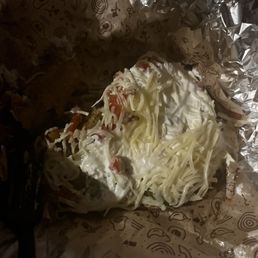 hard shell tacos with rice, beans, tomatoes, chicken, cheese, and lettuce