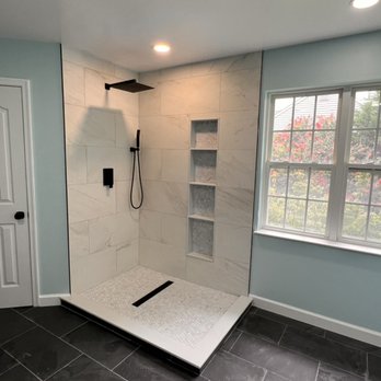 Andrés Zavaleta - a bathroom with a walk in shower - General Contractors Near Me Andrés Zavaleta - a bathroom with a walk in shower - General Contractors Near Me