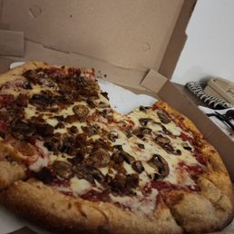 Mushroom, half sausage, regular crust pizza. Mushroom, half sausage, regular crust pizza.