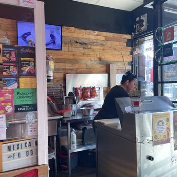 La Tienda - a man sitting at a counter in a restaurant - Latin American Near Me - Toronto, Ontario